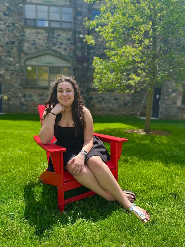 woman smiling in red chair