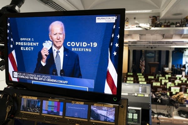 President-elect Joe Biden is shown on a monitor speaking about COVID-19 in the briefing room of the White House on Nov. 9.