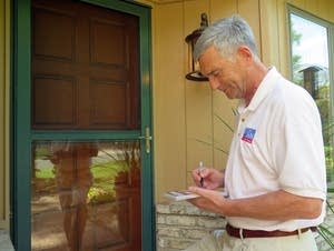 Republican state Sen. David Hann writes a note.