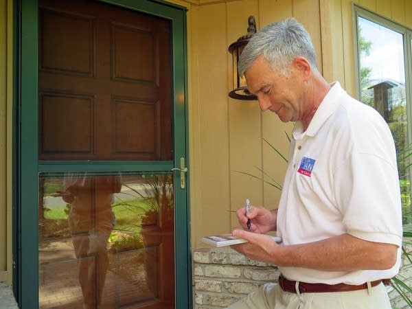 Republican state Sen. David Hann writes a note.