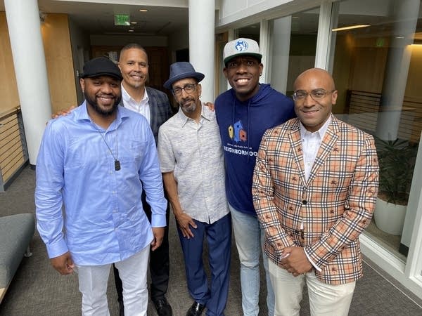 Five Black men smiling at camera 