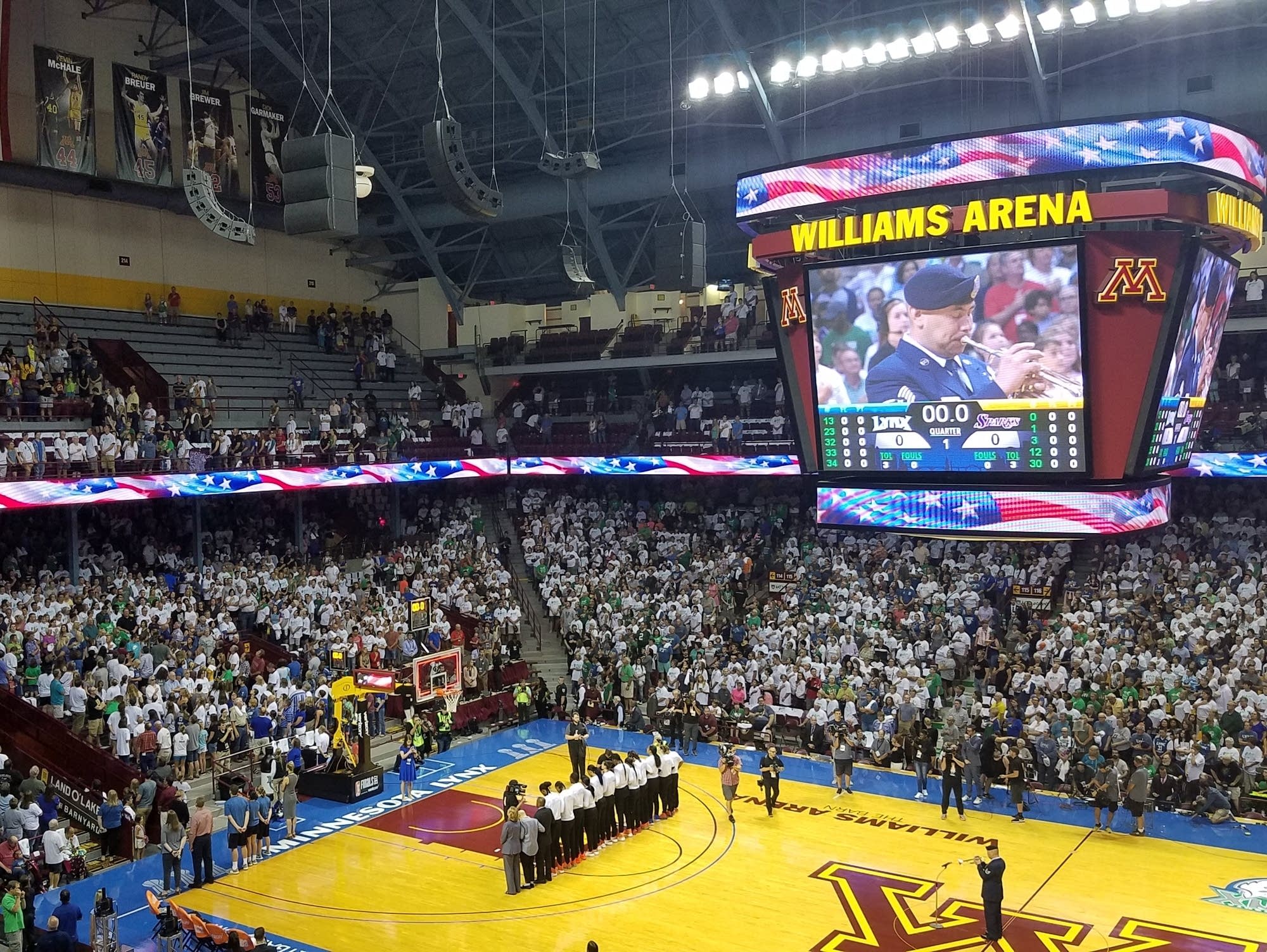 Members of the Minnesota Lynx lock arms at the national anthem plays