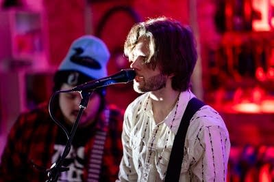 Two musicians performing onstage in a nontraditional music venue