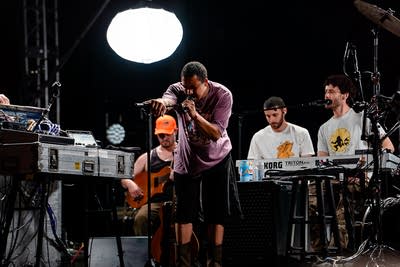 Dijon performing on an outdoor stage.