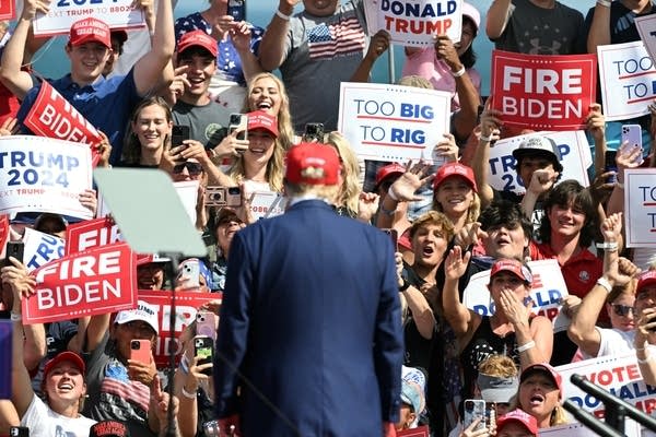 TOPSHOT - Supporters of former US President and Republican presidential candidate Donald Trump cheer as he arrives to speak at a campaign event in Racine, Wisconsin, on June 18, 2024.