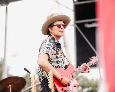 Person playing guitar on stage