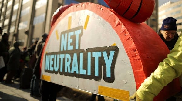 Rally organizers carry away props following a protest outside the Federal Communication Commission building against the end of net neutrality rules on December 14, 2017 in Washington, DC.