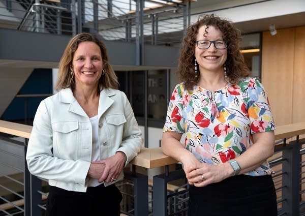 two women pose for a portrait