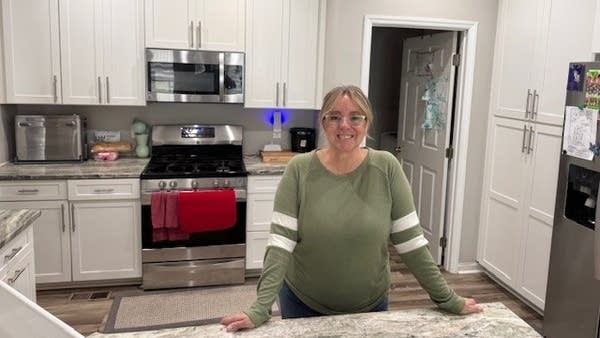 Heather Hill in her kitchen. Social Security survivor benefits was a financial lifeline for her family when her husband unexpectedly died.