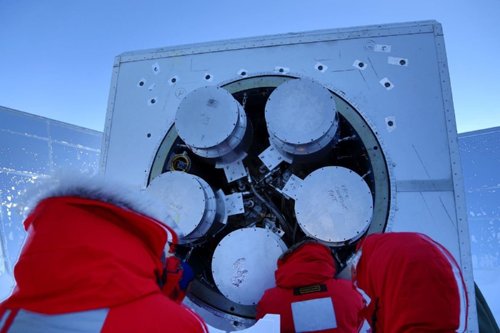 During the brief summer, researchers work to install a receiver