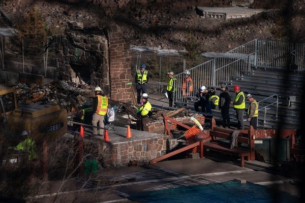 People in hard hats and vest on a site