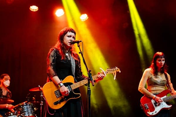 A band performing onstage in a music venue