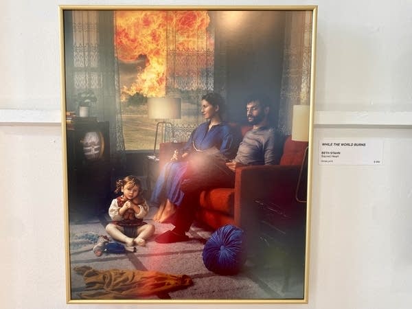 Painting of a family in their living room while a fire rages outside their window.