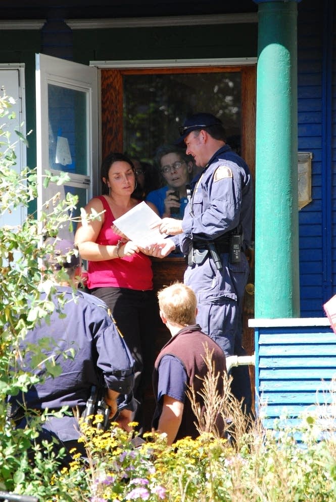Police show a search warrant to Sarah Coffey