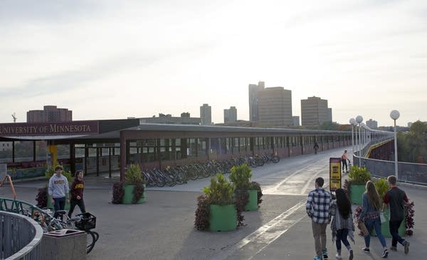 People walk near The Washington Avenue Bridge.