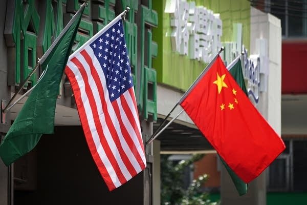 The US (L) and Chinese flags are displayed outside a hotel in Beijing on May 14, 2019. (Photo by Greg Baker / AFP)        (Photo credit should read GREG BAKER/AFP/Getty Images)