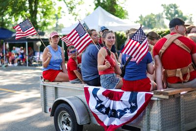 Residents hold American flags