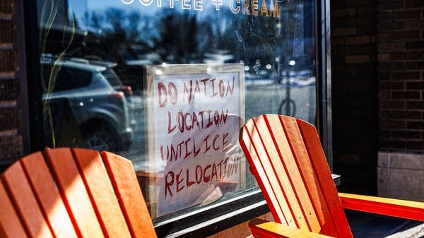 A sign reading “Donation location until ICE relocation” is posted in the window of Northern Coffeeworks, a coffee shop in Minneapolis.