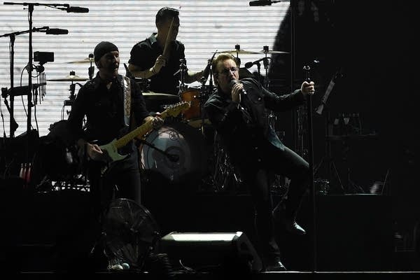 U2 performing in concert in 2019, generating revenue for the songwriters.