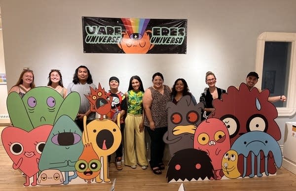 people posing for photo at gallery