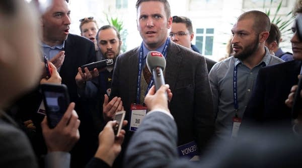  Reporters surround white supremacist Richard Spencer during a conference.