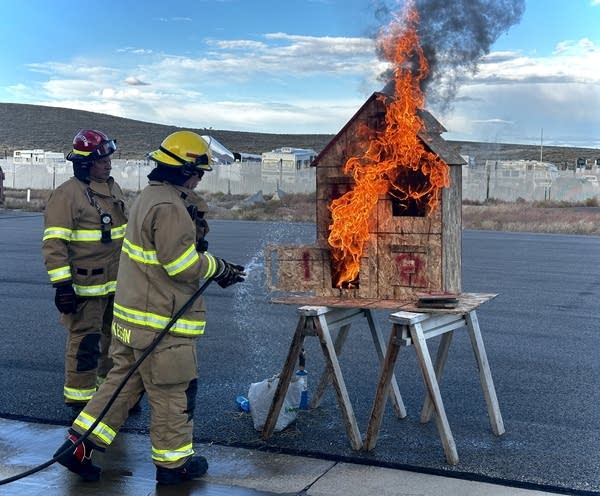 A couple of Sublette County, Wyoming volunteer firefighters help with a fire simulation. The crew has trainings a couple nights a month. 
