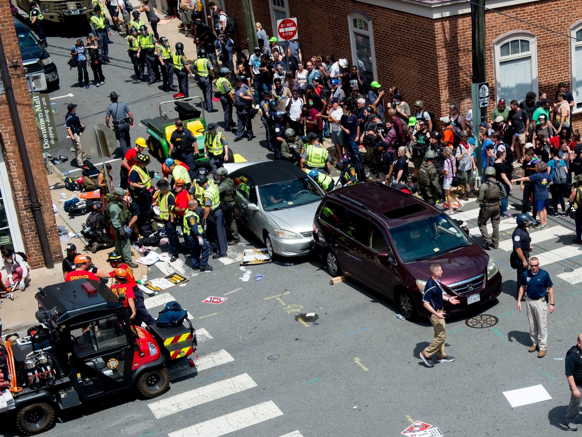 People receive first-aid after a car accident ran into a crowd