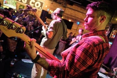 A musician plays bass onstage