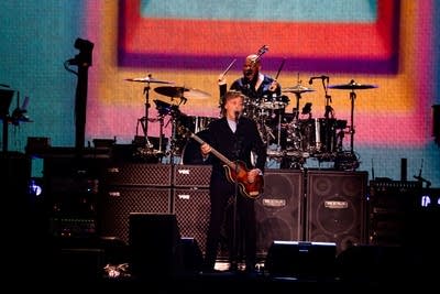 Paul McCartney performing on stage