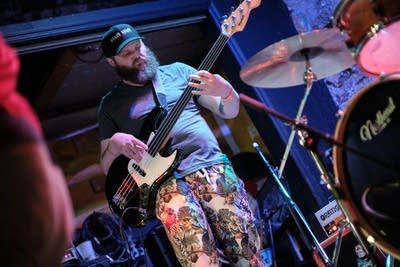 A musician plays bass onstage