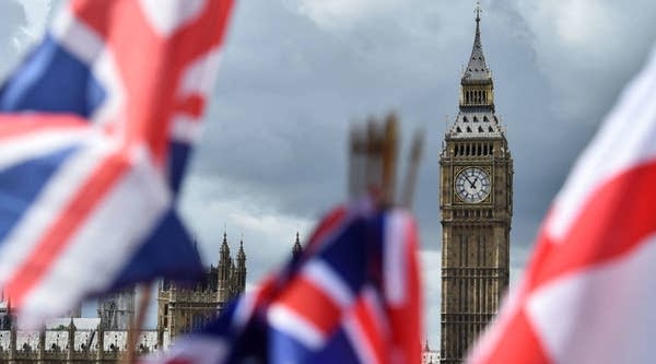 National flags flutter near the the Elizabeth Tower, commonly referred to as Big Ben, in central London today.