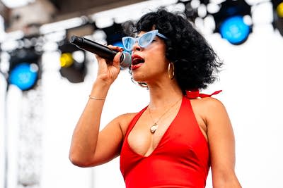 Monica Martin performing on an outdoor stage.