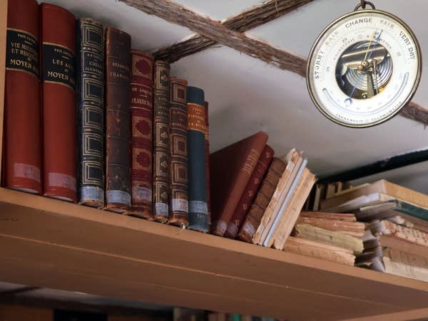 books on a shelf near the ceiling of a room