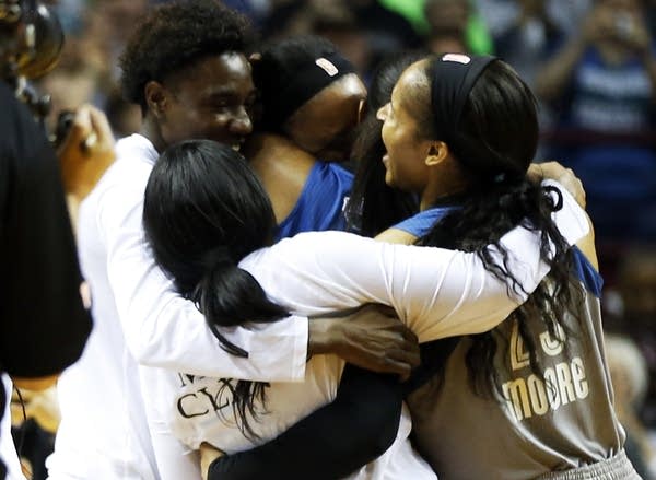 Maya Moore, right, and teammates celebrate after they win the championship.