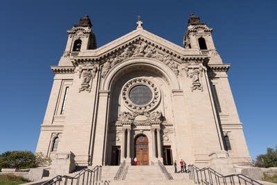 People wait outside of the Cathedral of Saint Paul
