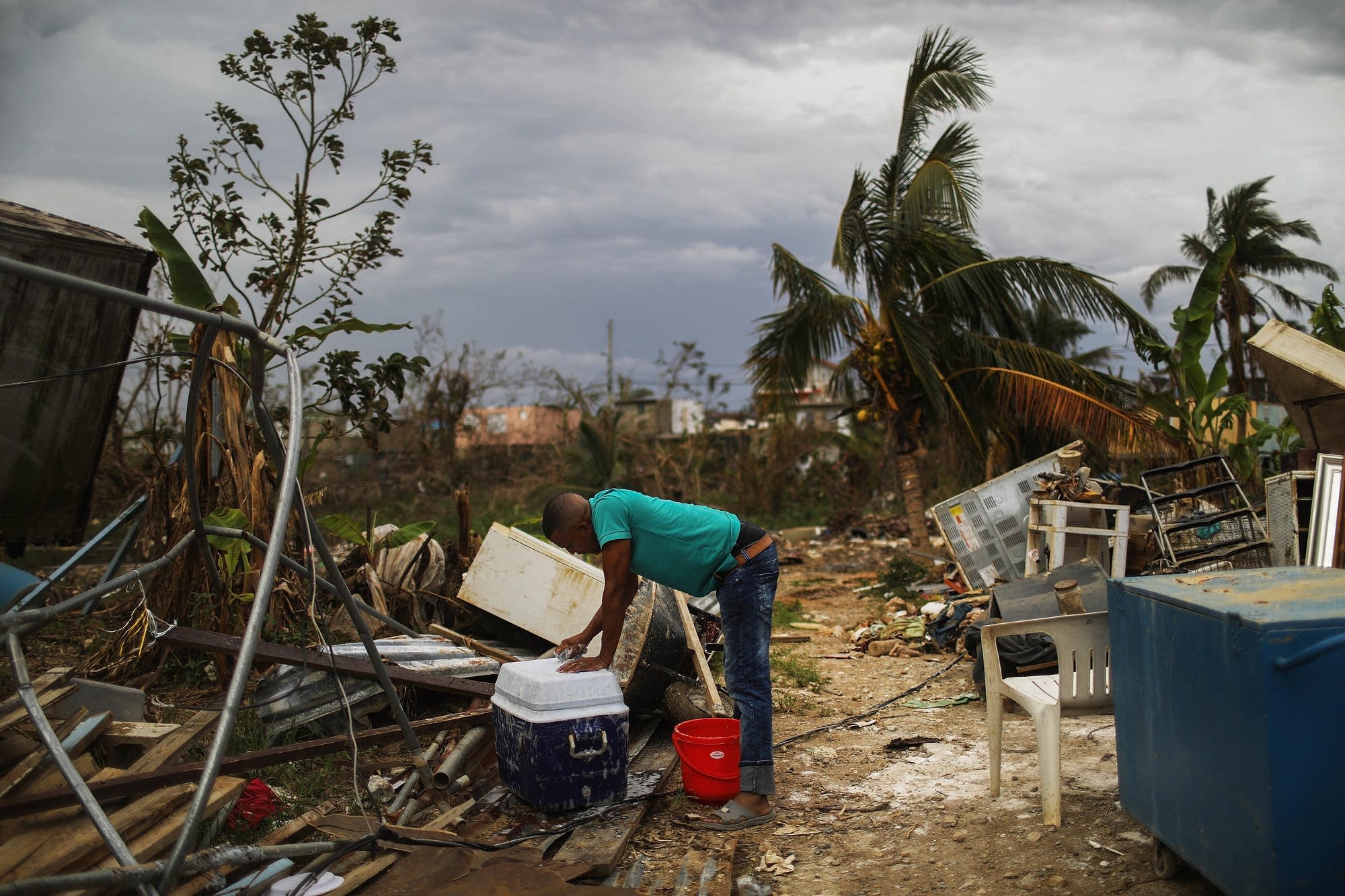 A resident cleans outside his home.