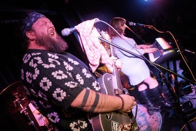 Two musicians performing onstage