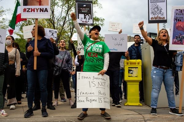 People hold signs and chant