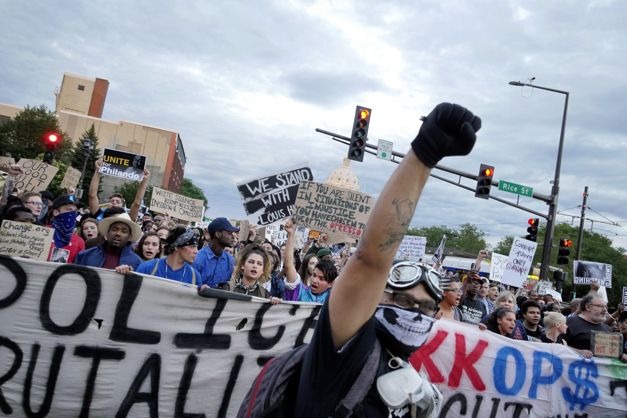 Marchers walk down University Ave. and block the Green Line light rail.