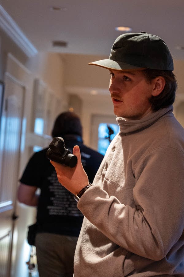a man holds a camera