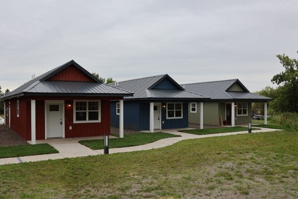 An exterior view of three housing residents.