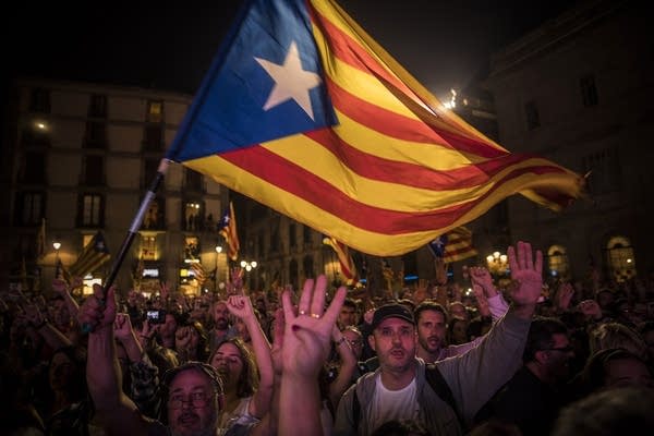 Pro-independence supporters cheer and wave