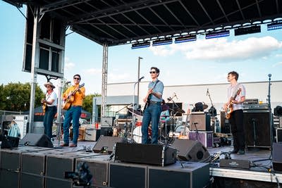 A band performing on an outdoor stage