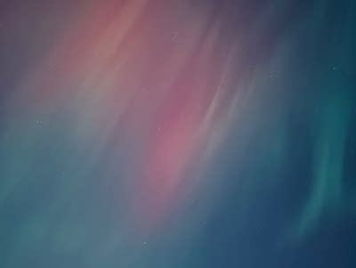 Green and red lights hang in the sky.