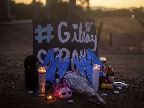 Candles burn at a memorial for Gilroy Garlic Festival shooting victims