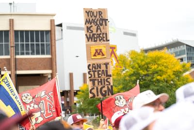Fans hold signs during the Big Noon Kickoff show