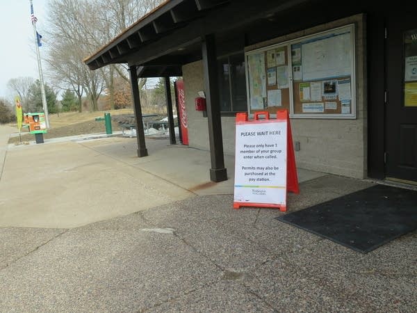 A sign sits outside of a building.