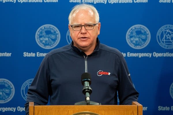 A man speaks at a podium.