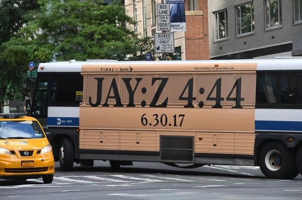 Bus in NYC with advertisement for Jay-Z's latest album