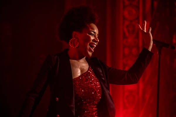 a woman singing on stage 